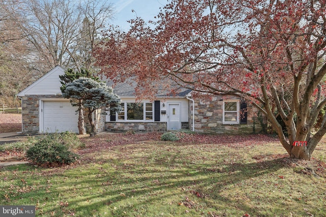 view of front of property with a garage and a front lawn