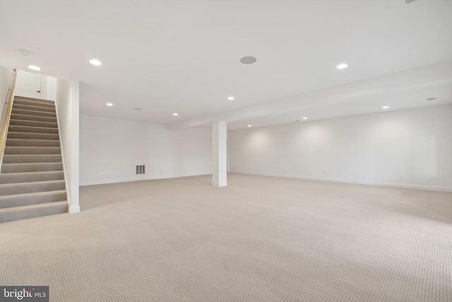 basement featuring light carpet