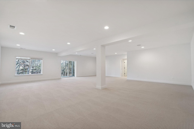 basement featuring light carpet