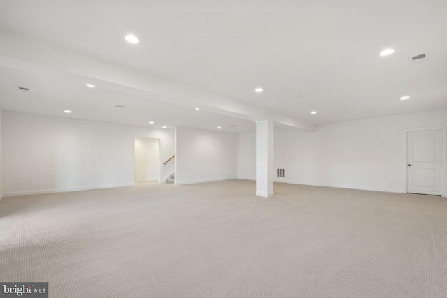 basement featuring light colored carpet