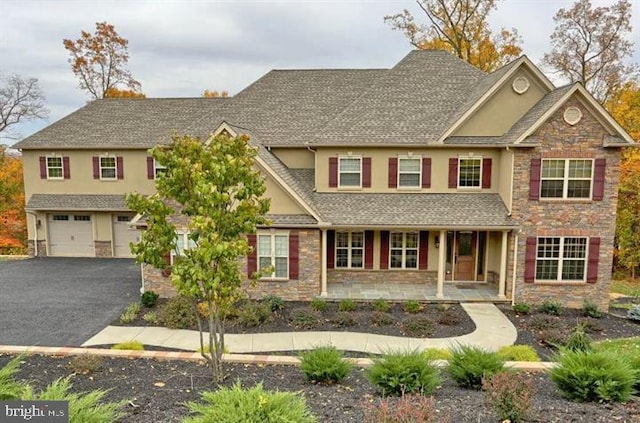 view of front of property featuring a porch and a garage