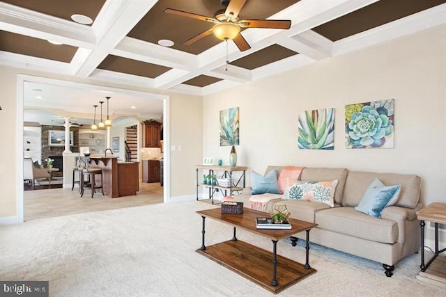 carpeted living room with ceiling fan, beamed ceiling, coffered ceiling, and crown molding