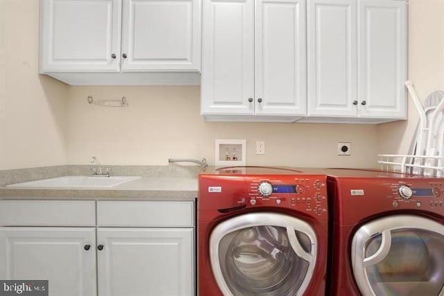 laundry area featuring sink, cabinets, and washing machine and dryer