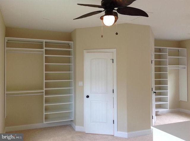 unfurnished bedroom featuring light carpet and ceiling fan