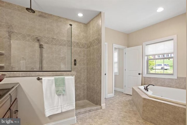 bathroom with separate shower and tub and vanity