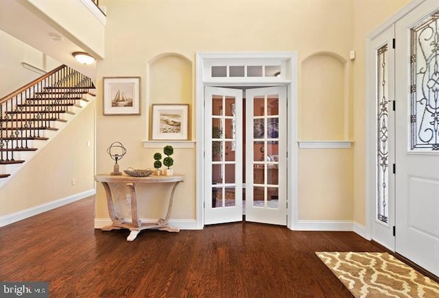 entryway with french doors and dark hardwood / wood-style floors