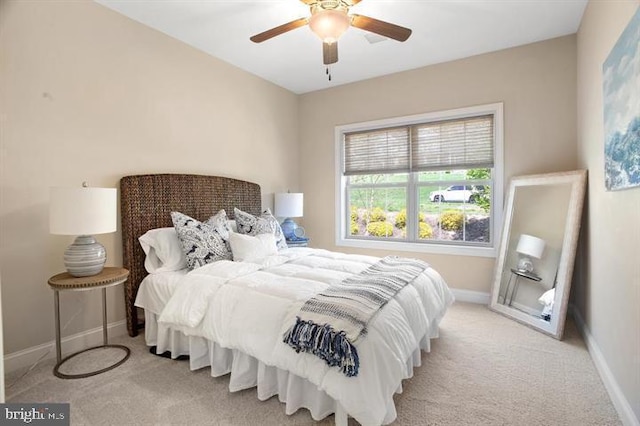 bedroom with ceiling fan and light colored carpet