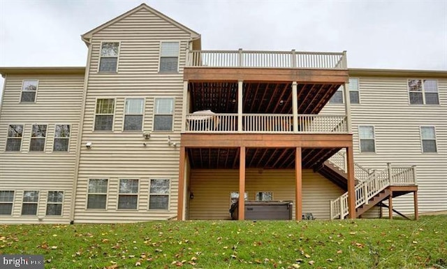 back of property featuring a lawn and a deck