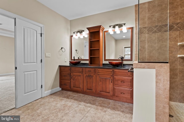 bathroom with tile patterned floors, walk in shower, and vanity