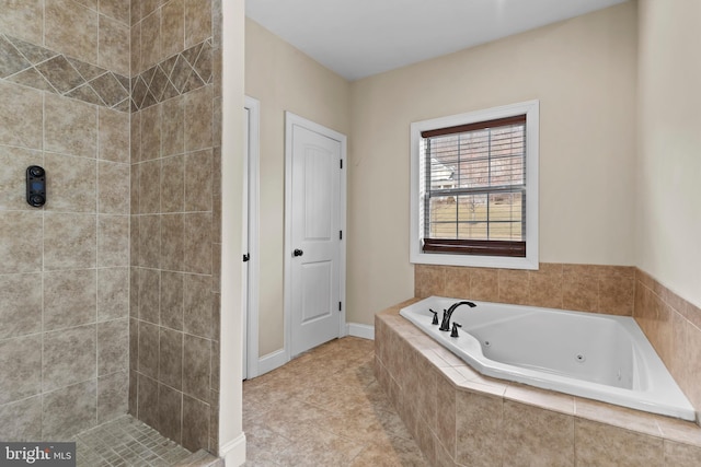 bathroom with tiled bath and tile patterned floors