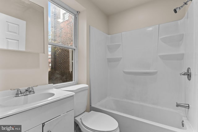 full bathroom featuring tub / shower combination, vanity, toilet, and a healthy amount of sunlight