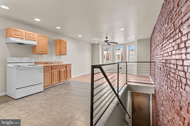 kitchen with light tile patterned flooring, light brown cabinetry, ceiling fan, and electric stove