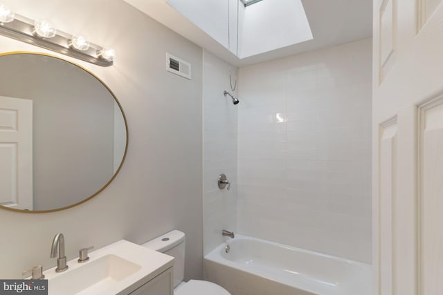 full bathroom featuring toilet, vanity, and tiled shower / bath