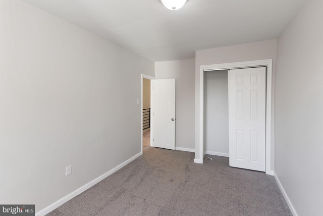 unfurnished bedroom featuring carpet and a closet