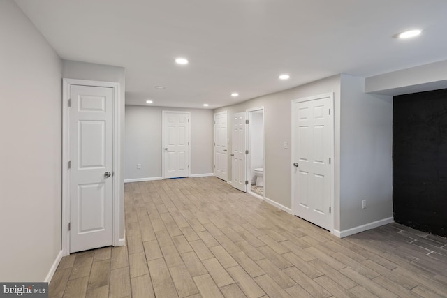 basement with light hardwood / wood-style floors