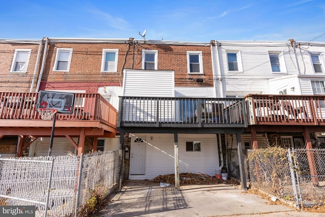 rear view of property featuring a wooden deck