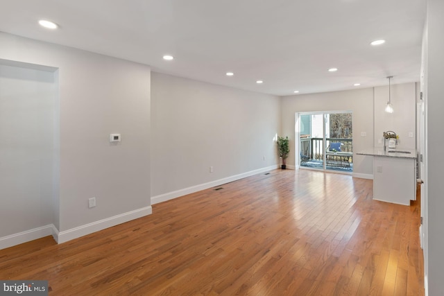 unfurnished living room featuring light wood-type flooring