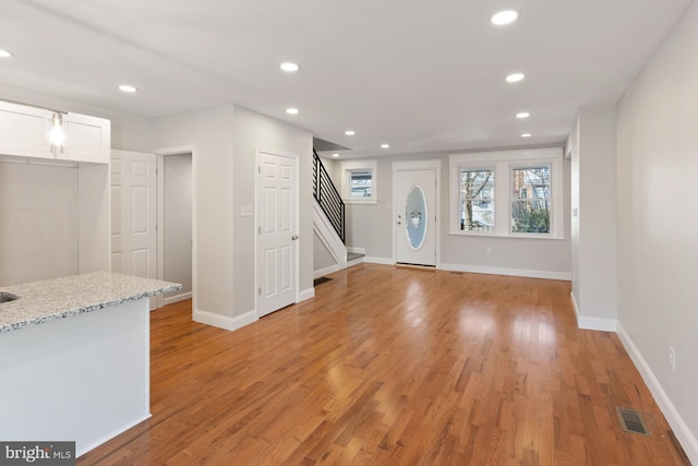 foyer entrance with light wood-type flooring