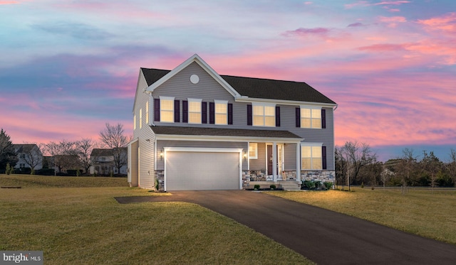 view of front facade featuring a garage and a lawn