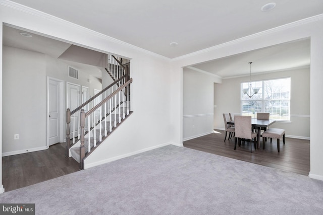 dining space featuring an inviting chandelier, crown molding, and dark wood-type flooring