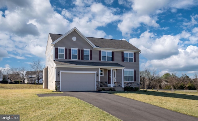 view of front facade with a garage and a front lawn