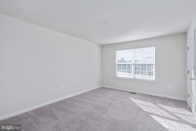 unfurnished room with light colored carpet