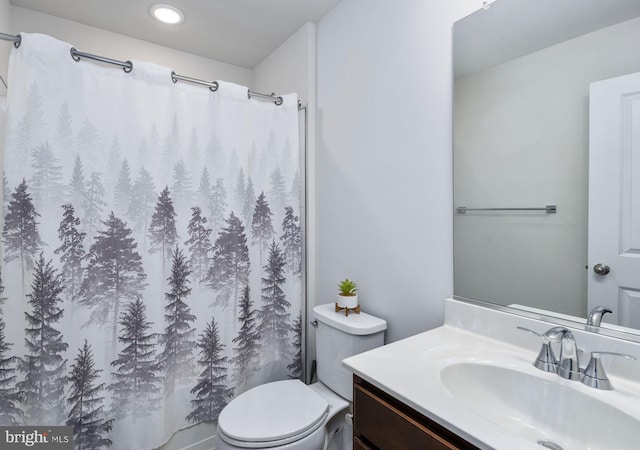 bathroom with vanity, toilet, and curtained shower