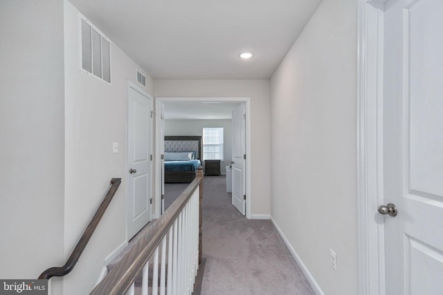 hallway with light colored carpet