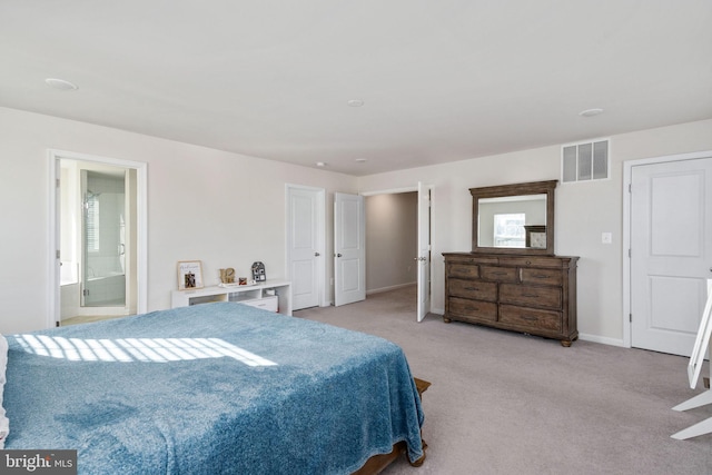 carpeted bedroom featuring ensuite bath