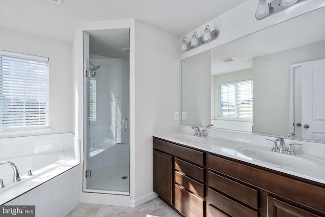 bathroom with tile patterned flooring, vanity, and independent shower and bath