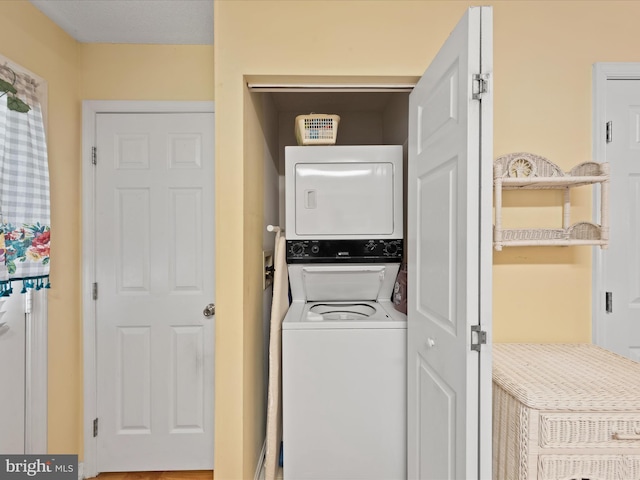 laundry area with stacked washer / dryer