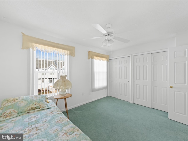 unfurnished bedroom with multiple closets, ceiling fan, and dark carpet