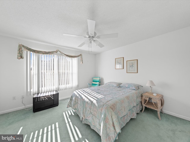 bedroom with carpet, ceiling fan, and a textured ceiling