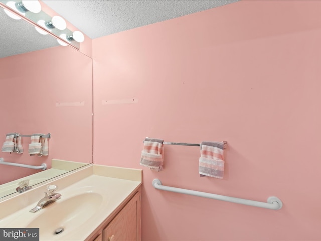 bathroom with vanity and a textured ceiling