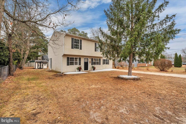 view of front of property with a storage shed