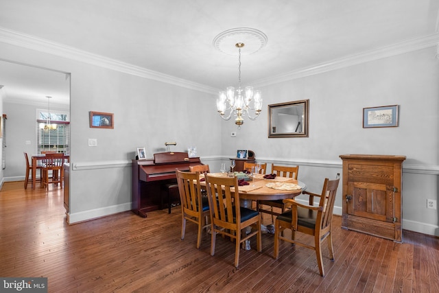 dining area featuring ornamental molding, a notable chandelier, and dark hardwood / wood-style flooring