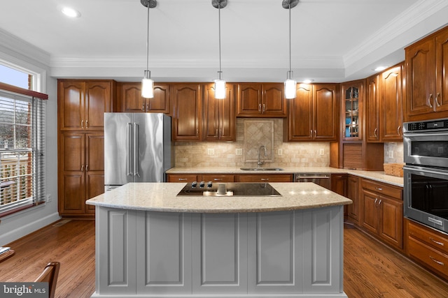 kitchen with light stone countertops, a center island, and appliances with stainless steel finishes