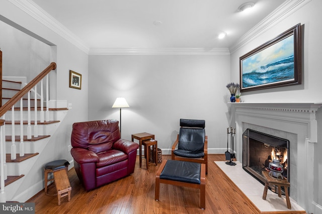 living room with ornamental molding and hardwood / wood-style floors