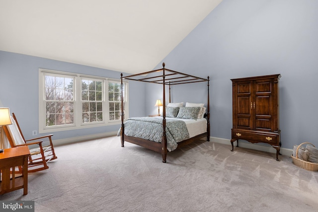 bedroom with light colored carpet and high vaulted ceiling