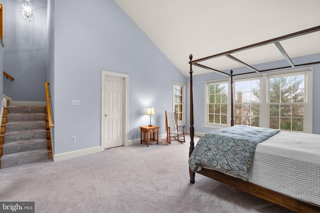 bedroom featuring high vaulted ceiling and carpet flooring