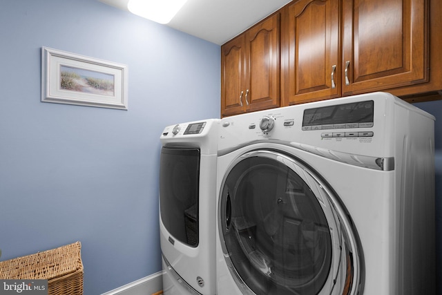 laundry room with cabinets and washing machine and dryer