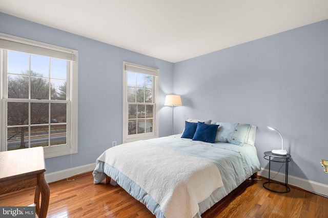 bedroom with hardwood / wood-style flooring