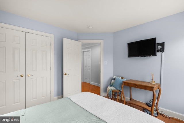 bedroom with hardwood / wood-style flooring and a closet