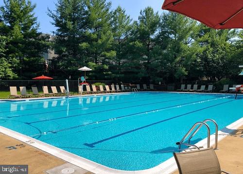 view of swimming pool with a playground