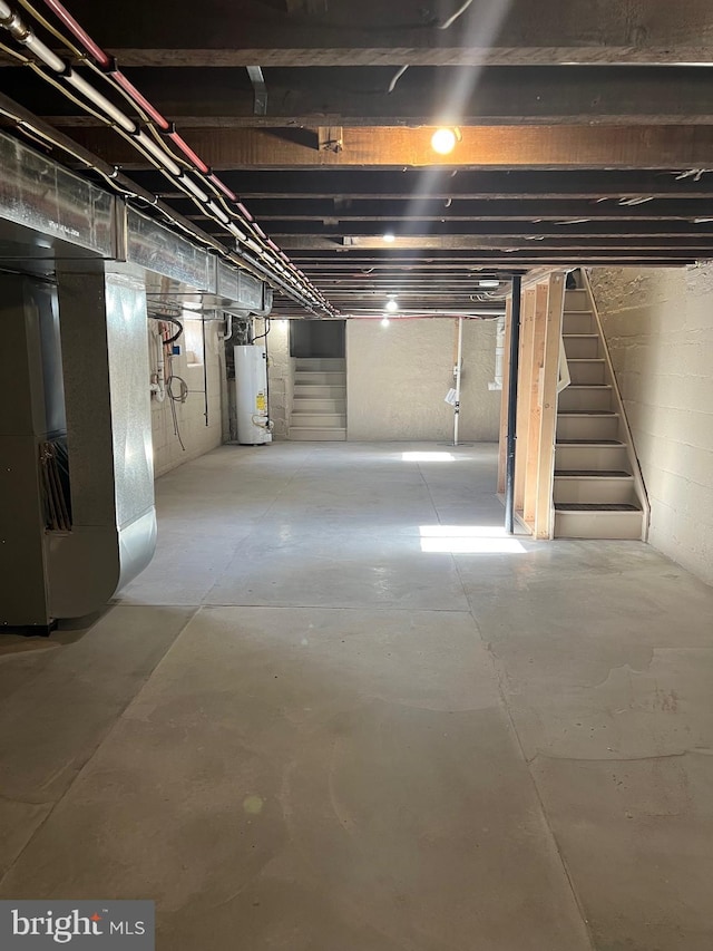 basement featuring gas water heater and heating unit