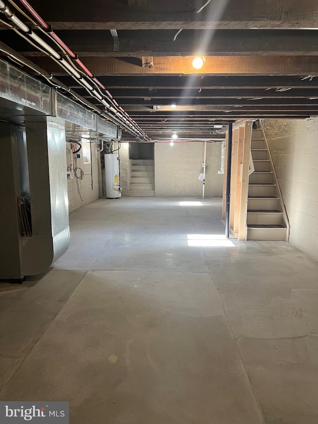 445 Magnolia St, Beverly, NJ 08010 - unfinished below grade area featuring water heater, stairway, and heating unit