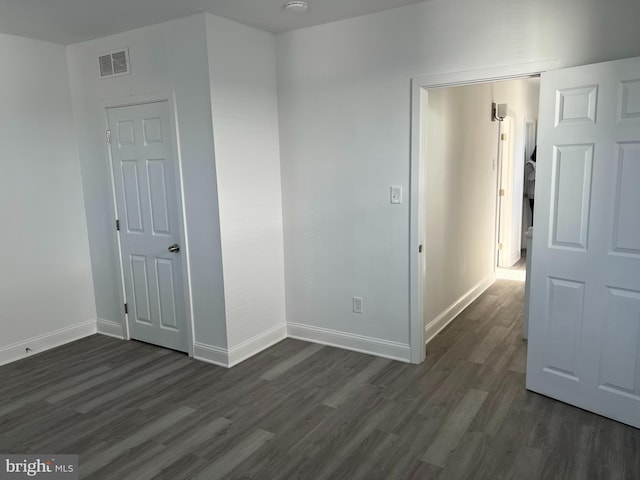 empty room featuring dark wood-type flooring