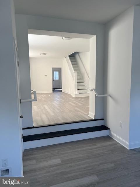 staircase with wood-type flooring