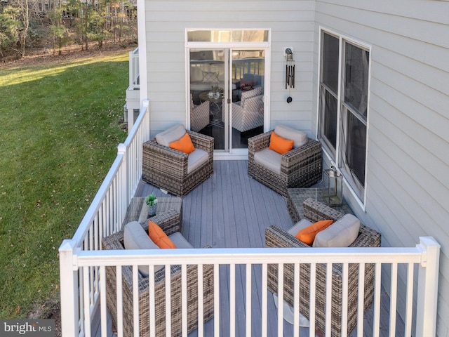 wooden deck featuring a lawn