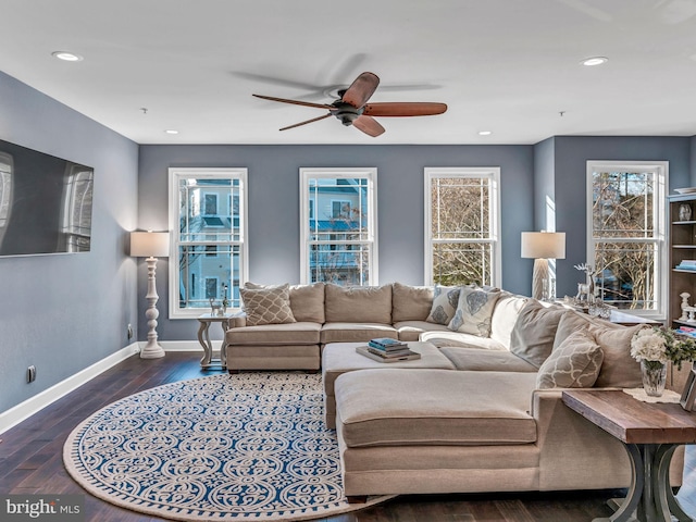 living room featuring ceiling fan and dark wood-type flooring